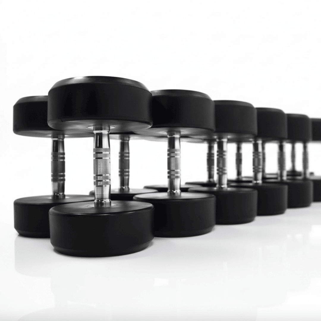 Close-up view of a row of professional round rubber dumbbells with polished chrome handles, suitable for commercial fitness centers.